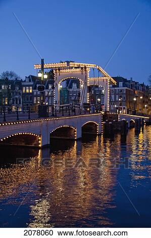 Magere Brug Over The Amstel River At Night, Amsterdam, Netherlands View Large Photo Image Stock Image - Magere Brug Over The Amstel River At Night, Amsterdam, Netherlands. Fotosearch