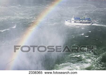 Stock Photography - Maid Of The Mist Boat Near Niagara Falls With Rainbow And Mist; Niagara Falls, New York, United States Of America. Fotosearch