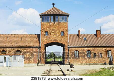 Stock Image - Main entrance of Birkenau death camp viewed from inside front gate; Osweciem, Poland. Fotosearch