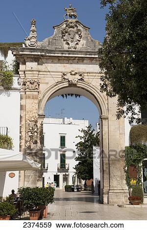 Stock Photo - Main gate leading to the old town of Martina Franca with traditional Puglian architecture; Martina Franca, Puglia, Italy. Fotosearch