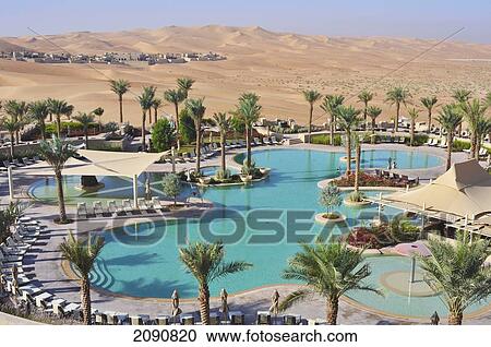 Stock Image - Main Pool And Dunes, Qasr Al Sarab, Abu Dhabi. Fotosearch