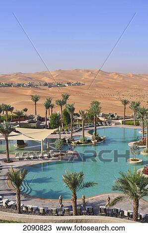 Stock Image - Main Pool And Dunes, Qasr Al Sarab, Abu Dhabi. Fotosearch