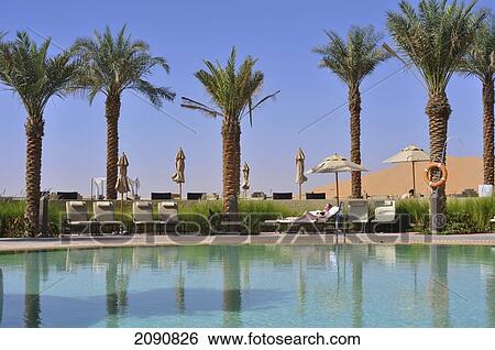 Stock Photograph - Main Pool And Dunes, Qasr Al Sarab, Abu Dhabi. Fotosearch