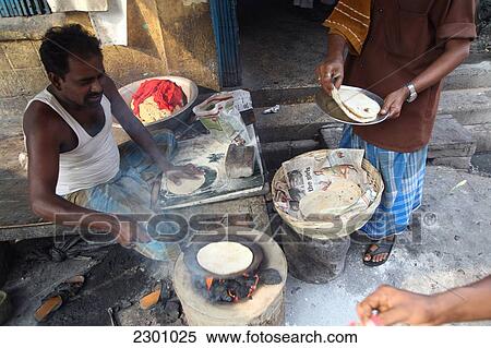 Making chapatti Indian bread on the street near New Market near Sudder Street, a popular backpacker budget accommodation district of Calcutta / Kolkata, the capital of West Bengal State, India, Asia. View Large Photo Image Stock Photography - Making chapatti Indian bread on the street near New Market near Sudder Street, a popular backpacker budget accommodation district of Calcutta / Kolkata, the capital of West Bengal State, India, Asia.. Fotosearch