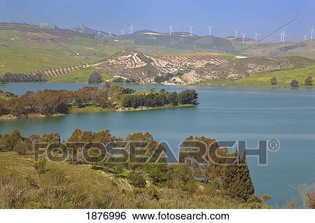Stock Photograph - Malaga, Andalusia, Spain; Conde De Guadalhorce Reservoir With Windmills In The Background. Fotosearch
