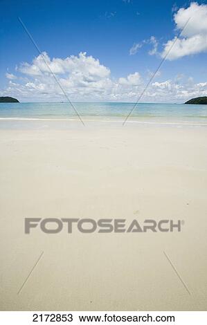 Malaysia, Pantai Cenang (Cenang beach); Pulau Langkawi, islands in background, Wide open view of white sandy beach and blue sky View Large Photo Image Stock Image - Malaysia, Pantai Cenang (Cenang beach); Pulau Langkawi, islands in background, Wide open view of white sandy beach and blue sky. Fotosearch