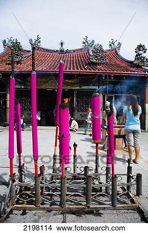 Picture - Malaysia, Pulau Pinang (Penang), Giant pink joss sticks burning at entrance of Kuan Yin Teng Chinese Temple (Temple of the Goddess of Mercy) Lebuh Pitt (Jalan Masjid Kapitan Keling) Road; Georgetown. Fotosearch
