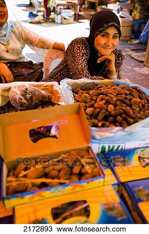 Malaysia, Terengganu, Pasar Payang central market; Kuala Terengganu, Female stall keepers selling dates at large indoor and outdoor market View Large Photo Image Stock Image - Malaysia, Terengganu, Pasar Payang central market; Kuala Terengganu, Female stall keepers selling dates at large indoor and outdoor market. Fotosearch