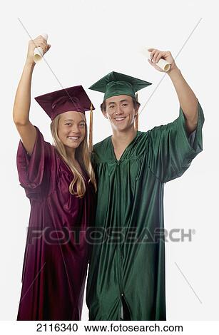 Male and female graduates in cap and gown, holding diplomas. View Large Photo Image Stock Image - Male and female graduates in cap and gown, holding diplomas.. Fotosearch