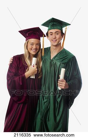 Stock Photography - Male and female graduates in cap and gown, holding diplomas.. Fotosearch