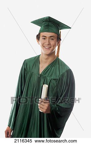 Stock Photography - Male graduate in cap and gown, holding diploma.. Fotosearch