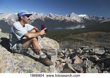 Male Hiker Resting With Water Bottle, Jasper National Park, Alberta, Canada View Large Photo Image Picture - Male Hiker Resting With Water Bottle, Jasper National Park, Alberta, Canada. Fotosearch