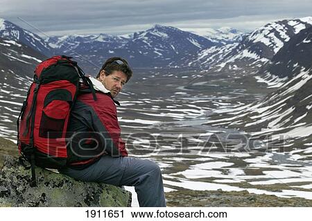 Stock Image - Male Hiker Sitting On Rock On Kungsleden Trail, Portrait, Abisko, Sweden. Fotosearch