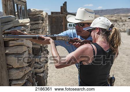 Male Instructor Guides Young Woman About How To Fire Shotgun At Lajitas Resort, Big Bend National Park And Big Bend State Park, South West Texas, Usa View Large Photo Image Stock Image - Male Instructor Guides Young Woman About How To Fire Shotgun At Lajitas Resort, Big Bend National Park And Big Bend State Park, South West Texas, Usa. Fotosearch
