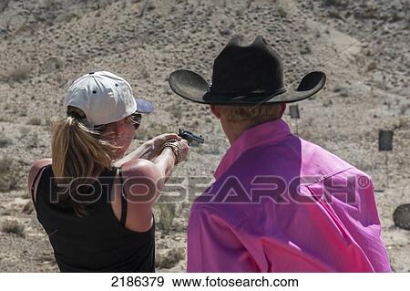 Male Instructor Guides Young Woman About How To Fire Shotgun At Lajitas Resort, Big Bend National Park And Big Bend State Park, South West Texas, Usa View Large Photo Image Stock Photo - Male Instructor Guides Young Woman About How To Fire Shotgun At Lajitas Resort, Big Bend National Park And Big Bend State Park, South West Texas, Usa. Fotosearch