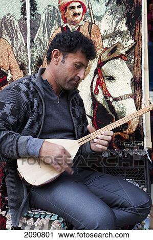 Male Souvenir Seller Playing Musical Instrument At Citadel In Erbil, Iraqi Kurdistan, Iraq View Large Photo Image Stock Image - Male Souvenir Seller Playing Musical Instrument At Citadel In Erbil, Iraqi Kurdistan, Iraq. Fotosearch