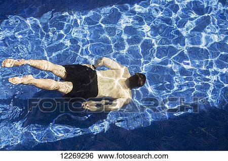 Stock Photograph - Male swimming under water in pool; Akumal, Quintana Roo, Mexico. Fotosearch