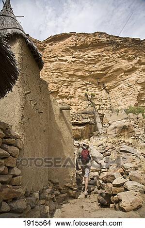 Male Tourist Walking Among Dogon Village Buildings At Bandiagara Escarpment View Large Photo Image Picture - Male Tourist Walking Among Dogon Village Buildings At Bandiagara Escarpment. Fotosearch