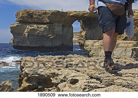 Stock Photo - Male Tourist Walking On Coastal Cliff Near Azure Window, Low Section. Fotosearch