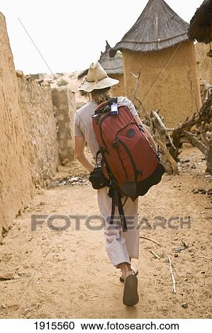 Male Tourist Walking Through Koundou Village At Bandiagara Escarpment View Large Photo Image Stock Image - Male Tourist Walking Through Koundou Village At Bandiagara Escarpment. Fotosearch