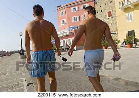 Stock Photography - Male tourists in swimming trunks; Piran, Slovenia. Fotosearch