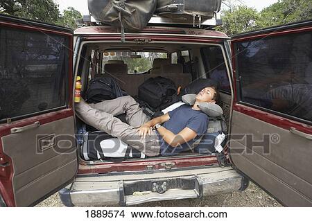 Male Traveler Taking A Nap In The Back Of A 4X4 View Large Photo Image Picture - Male Traveler Taking A Nap In The Back Of A 4X4. Fotosearch