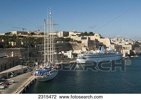 Malta, Valetta, Two cruise ships moored in Grand Harbor under fortress walls View Large Photo Image Stock Image - Malta, Valetta, Two cruise ships moored in Grand Harbor under fortress walls. Fotosearch