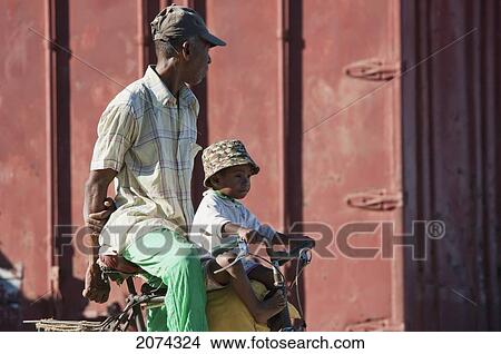 Man And Boy On A Bicycle In Mahavatse, Toliara Province, Madagascar View Large Photo Image Picture - Man And Boy On A Bicycle In Mahavatse, Toliara Province, Madagascar. Fotosearch