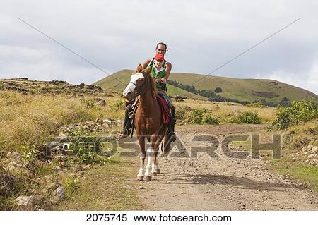 Stock Photography - Man And Boy On Horseback By Ahu Tepeu, Rapa Nui (Easter Island), Chile. Fotosearch