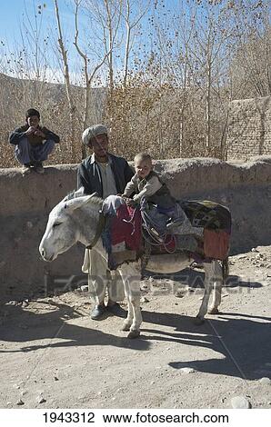 Man And His Boy On A Donkey In The Aqrabat Valley, Bamian Province, Afghanistan View Large Photo Image Stock Image - Man And His Boy On A Donkey In The Aqrabat Valley, Bamian Province, Afghanistan. Fotosearch
