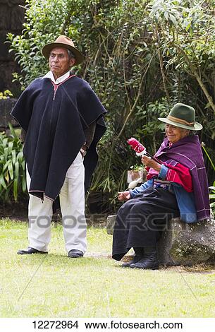 Picture - Man and old woman spinning cotton at Hacienda San Agustin de Callo, Cotopaxi, Ecuador. Fotosearch