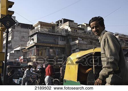 Stock Image - Man And Rickshaw Near Textile Market In The Old Delhi, Uttar Pradesh, India. Fotosearch