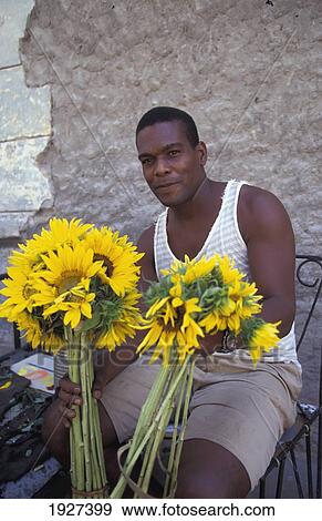 Stock Photo - Man And Sunflowers. Fotosearch