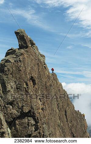 Picture - Man ascending The Inaccessible Pinnacle at the summit of Sgurr Dearg; Isle of Skye, Scotland. Fotosearch
