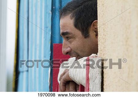 Man At A Window, Puerto Aguirre, Aysen Region, Chile View Large Photo Image Stock Photo - Man At A Window, Puerto Aguirre, Aysen Region, Chile. Fotosearch