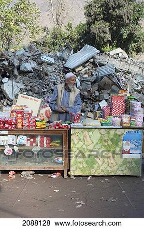 Man At His Shop In Front Of The Bazaar Destroyed By The 8 October 2005 Earthquake, Chinari, Azad Kashmir, Pakistan View Large Photo Image Stock Photo - Man At His Shop In Front Of The Bazaar Destroyed By The 8 October 2005 Earthquake, Chinari, Azad Kashmir, Pakistan. Fotosearch