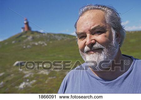 Stock Image - Man At Lighthouse; Trepassey, Newfoundland, Canada. Fotosearch