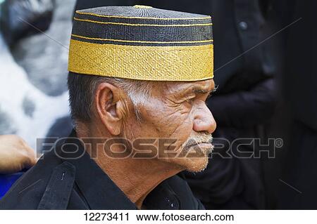 Man attending a funeral ceremony at a rante, the ceremonial site for a Torajan funeral, in Sereale, Toraja Land, South Sulawesi, Indonesia View Large Photo Image Stock Image - Man attending a funeral ceremony at a rante, the ceremonial site for a Torajan funeral, in Sereale, Toraja Land, South Sulawesi, Indonesia. Fotosearch