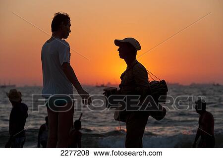 Man bargaining for drums on the beach; Goa, India View Large Photo Image Stock Photo - Man bargaining for drums on the beach; Goa, India. Fotosearch