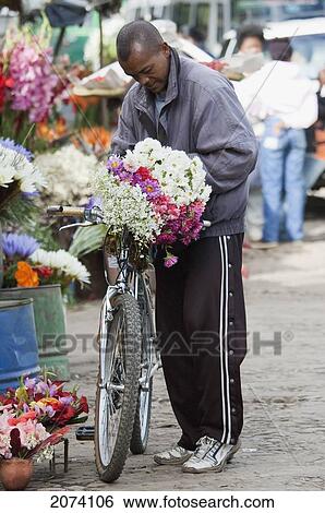Man Buying Flowers In The Flower Market By Lake Anosy In Antananarivo, Madagascar View Large Photo Image Stock Photograph - Man Buying Flowers In The Flower Market By Lake Anosy In Antananarivo, Madagascar. Fotosearch