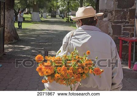 Stock Photo - Man Carrying A Marigolds For The Celebration Of D. Fotosearch