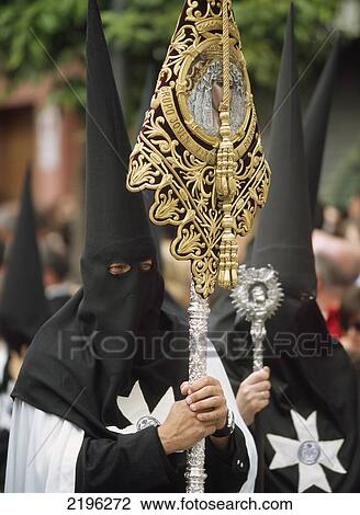 Stock Image - Man Carrying Banner Of The Virgin Mary In Semana Santa Parade Going Through Seville, Seville, Andalucia, Spain.. Fotosearch