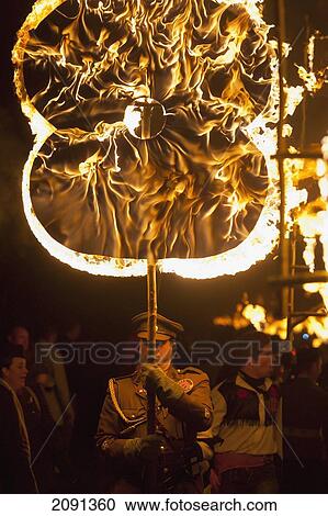 Man Carrying Burning Poppy To Commemorate War Dead From The Village On Bonfire Night, East Hoathly, East Sussex, Uk View Large Photo Image Stock Image - Man Carrying Burning Poppy To Commemorate War Dead From The Village On Bonfire Night, East Hoathly, East Sussex, Uk. Fotosearch