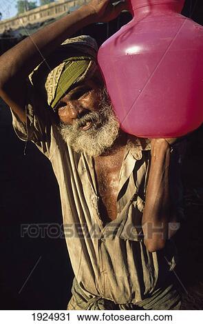 Stock Image - Man Carrying Jug Of Water. Fotosearch