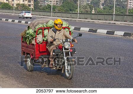 Stock Photo - Man Carrying Vegetables On His Motorized Tricycle, Cairo, Al Qahirah, Egypt. Fotosearch
