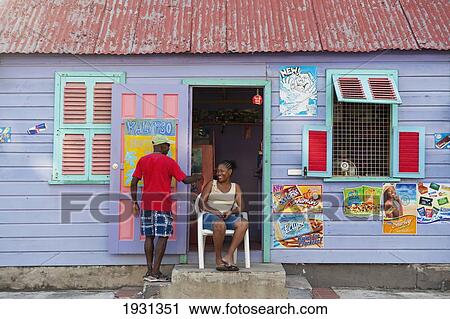 Man Chatting To Lady Outside A Colorful Shop, Paynes Bay, Barbados; Paynes Bay, Barbados. 
 View Large Photo Image Stock Image - Man Chatting To Lady Outside A Colorful Shop, Paynes Bay, Barbados; Paynes Bay, Barbados. 
. Fotosearch