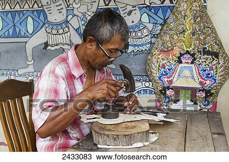Man chiselling leather with very fine tools in the construction of a Wayang Kulit shadow puppet, Yogyakarta, Java Island, Indonesia View Large Photo Image Stock Image - Man chiselling leather with very fine tools in the construction of a Wayang Kulit shadow puppet, Yogyakarta, Java Island, Indonesia. Fotosearch