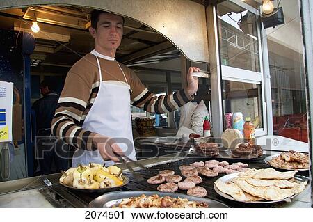 Stock Image - Man Cooking Food, Prishtina, Kosovo. Fotosearch