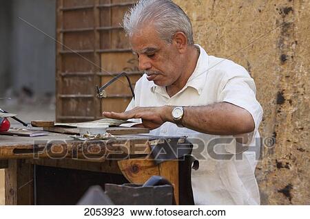 Man Cutting Metal Dishes, Cairo, Al Qahirah, Egypt View Large Photo Image Stock Image - Man Cutting Metal Dishes, Cairo, Al Qahirah, Egypt. Fotosearch
