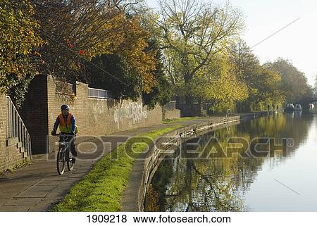 Man Cycling Along Regents Canal, London, England, Uk View Large Photo Image Stock Photo - Man Cycling Along Regents Canal, London, England, Uk. Fotosearch